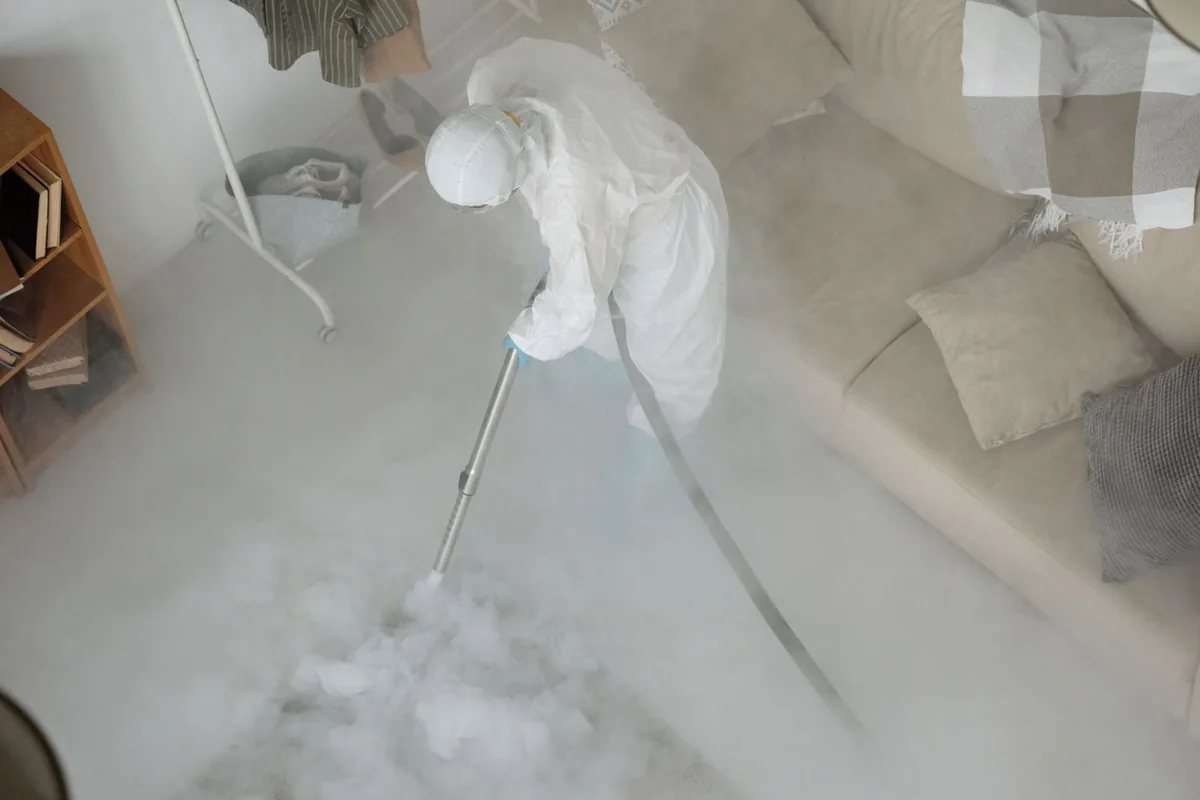Biohazard cleanup technician in protective equipment, Thompson, ND